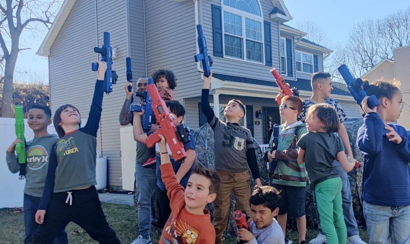 Group of kids holding laser tag equipment